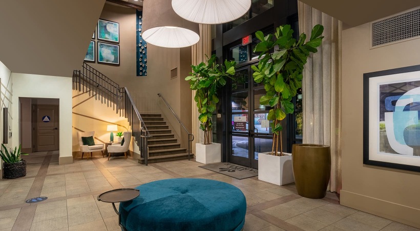 Lobby spacious lobby area with green indoor trees and easy to access stairs